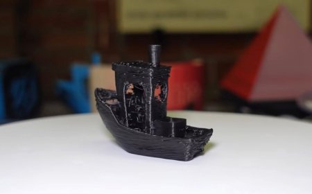 A custom Minuteman printer displays a 3DBenchy model completed in under sixty seconds.