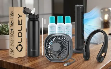 A compact desk fan provides cooling airflow on a professional workspace desk alongside office supplies.