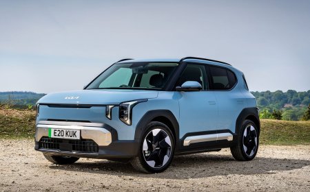 The Kia EV2 compact electric vehicle is parked on a city street.