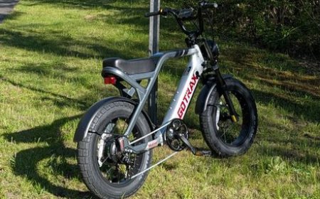 The Gotrax Mustang electric bike features a moped-style frame, fat tires, and front suspension.