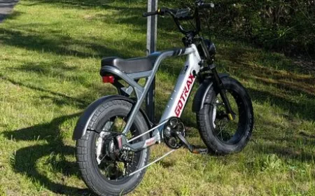 The Gotrax Mustang electric bike features a moped-style frame, fat tires, and front suspension.