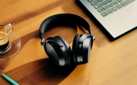 The Sennheiser Momentum 5 headphones show the replaceable battery compartment and four microphones per ear cup.