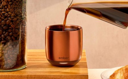Ember Temperature Control Smart Cup resting on its magnetic charging base