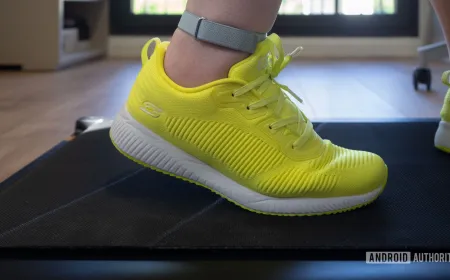 Fitbit Air tracker secured to an ankle strap during treadmill walking to demonstrate improved step counting accuracy.