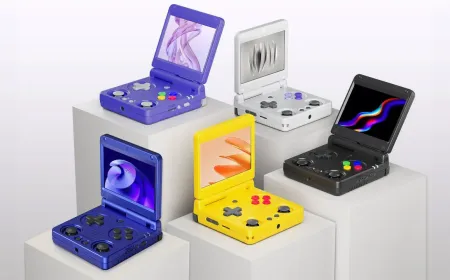 An Anbernic retro gaming handheld console resting on a surface with its screen turned on.