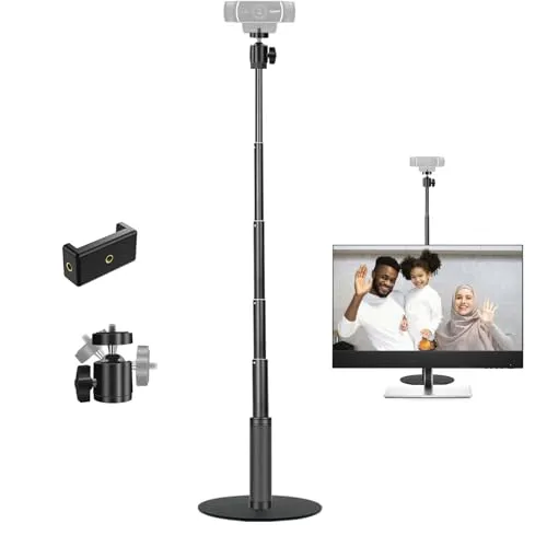 A webcam is mounted on a monitor frame next to a ring light and desktop microphone.