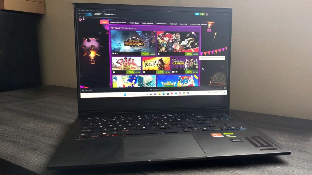 The HP Omen 16 laptop sits open on a desk, displaying its keyboard, screen, and side ports.