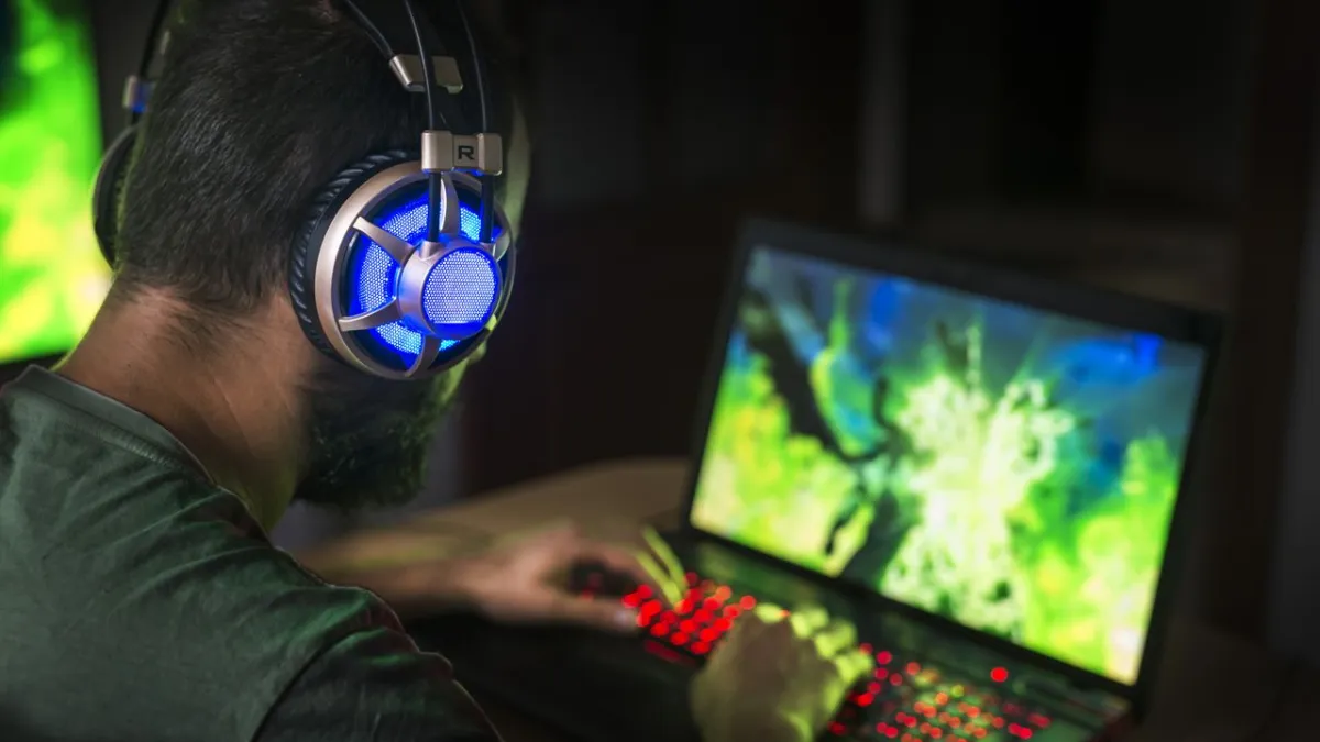 Promotional material contrasts Windows gaming compatibility with the MacBook Neo productivity focus.