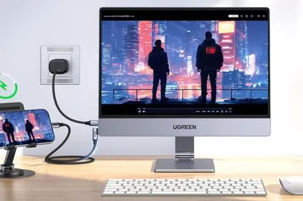 A slim Ugreen portable monitor displays a crisp interface on a flat surface.