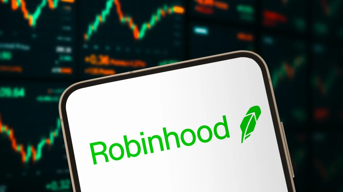 A computer screen displays the SpaceX and Robinhood logos alongside financial charts.