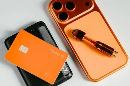 Nomad Stellar Orange Tracking Card Pro and Stand One charger displayed together