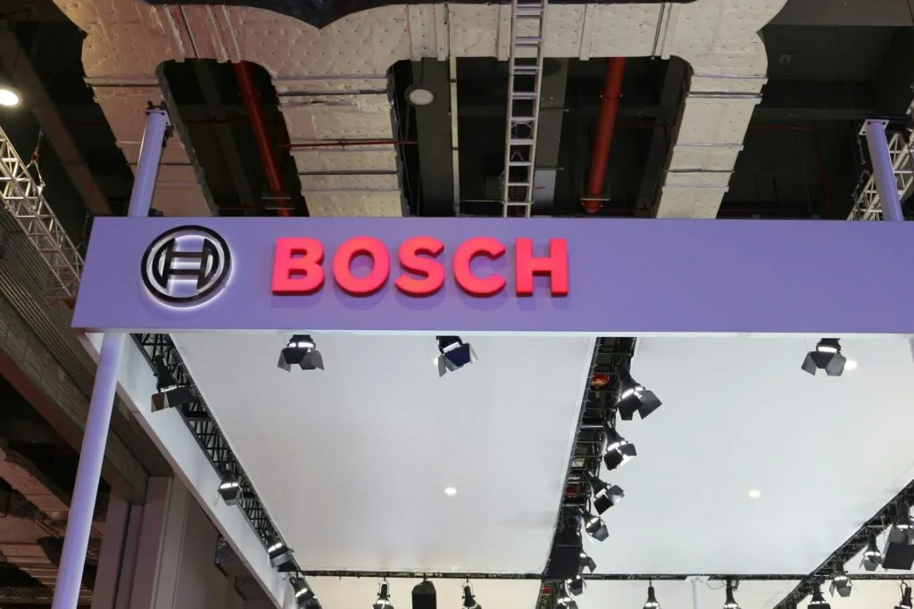 A humanoid robot stands in a factory, showing Bosch's strategic shift toward industrial automation and artificial intellig...