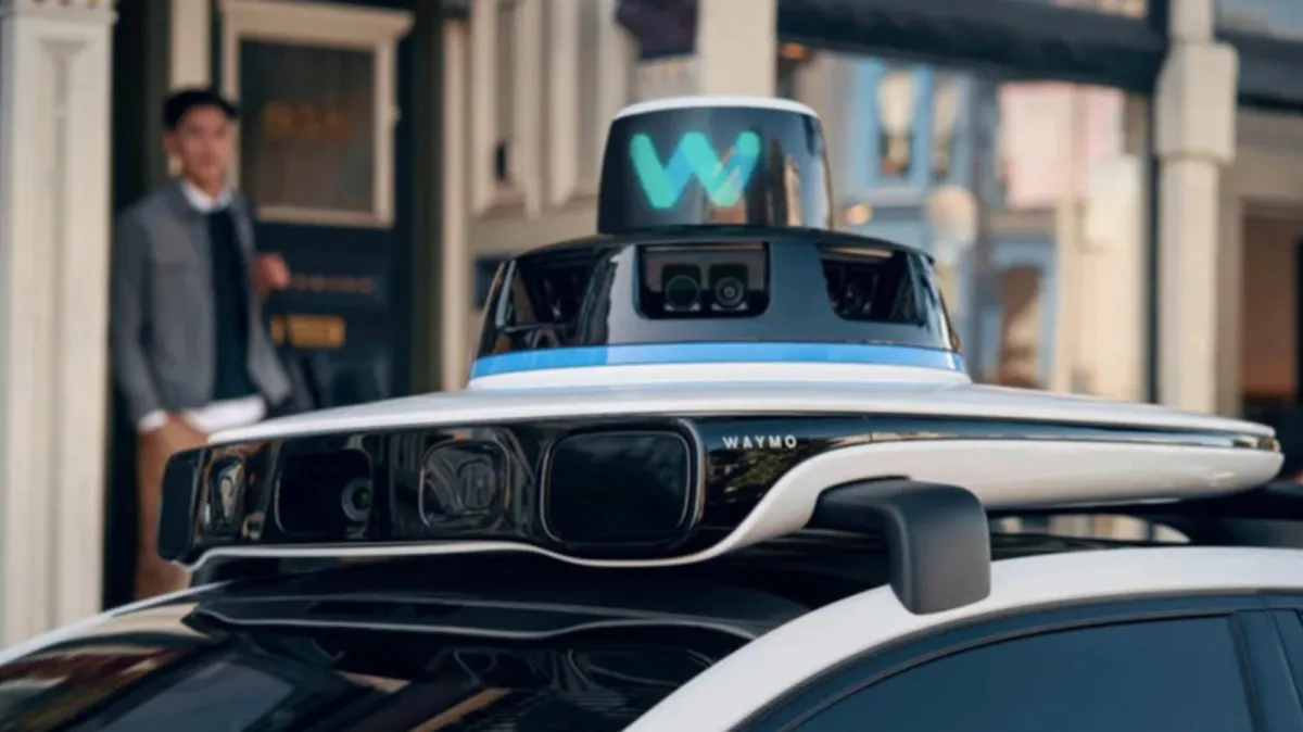A white Waymo robotaxi sits parked on a city street, highlighting autonomous vehicle data retention policies.