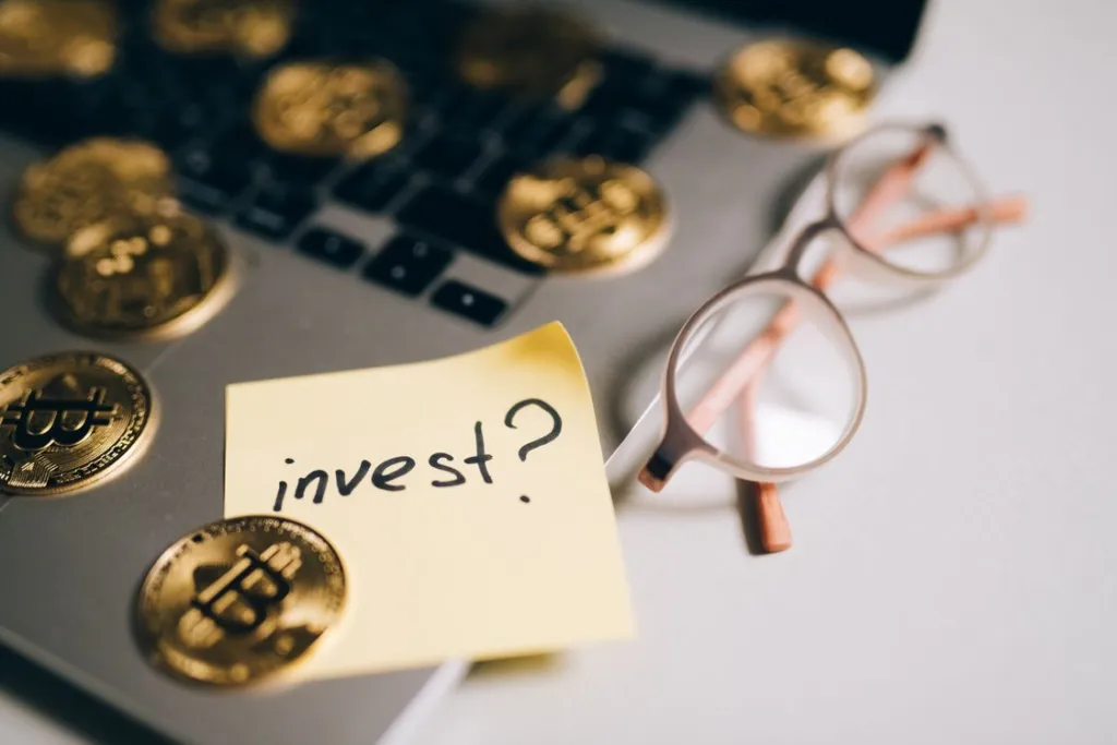 A person reviews security features and fee structures while opening a digital investment account on a laptop.