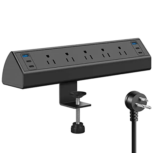 A desk-mounted power strip is installed beneath a workstation with multiple outlets and cable management channels.