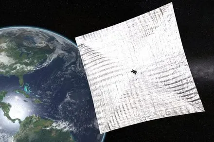A schematic diagram illustrates a laser-driven lightsail encountering drag at relativistic speeds.