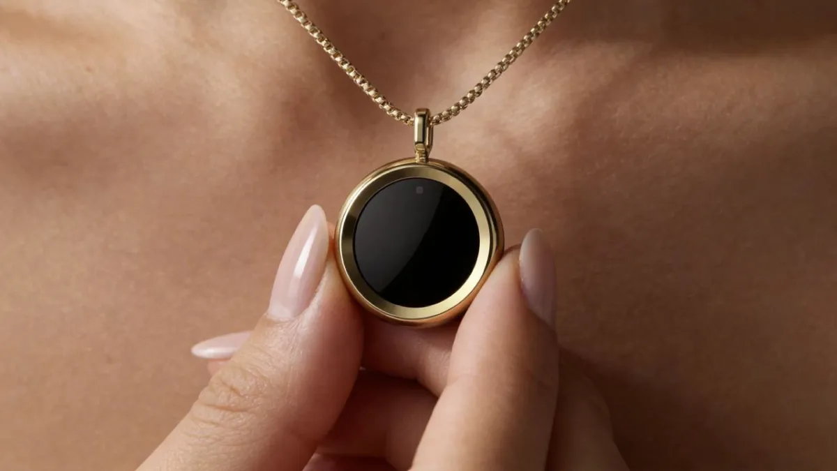 The Gem necklace is worn on a model to display its compact UV sensor and companion app interface for tracking sun exposure.