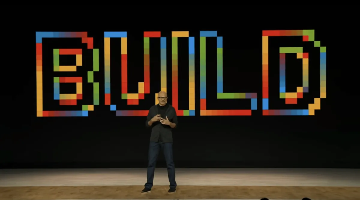 Conference stage at Microsoft Build 2026 displaying announcements for autonomous agents and developer hardware.