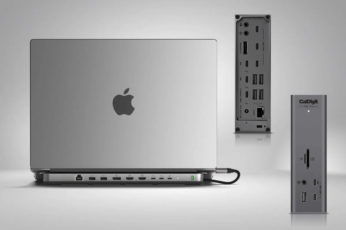 A Thunderbolt 5 docking station connects to a MacBook with multiple peripheral cables and display adapters attached.