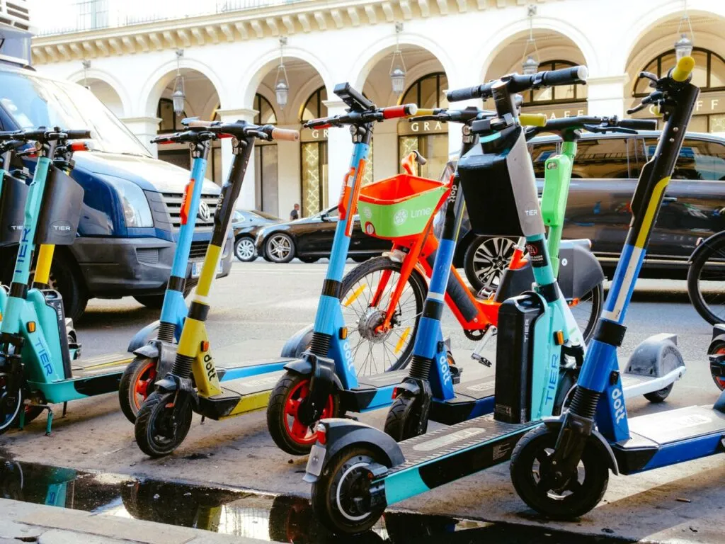 Rental e-scooters are parked along a Brussels street ahead of the municipal ban.