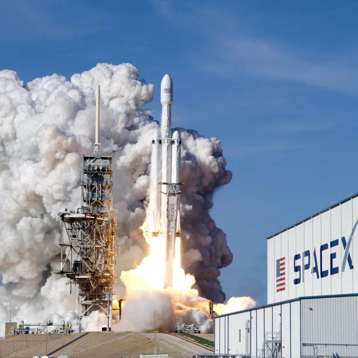 SpaceX rocket launch facility with technical staff conducting routine operations
