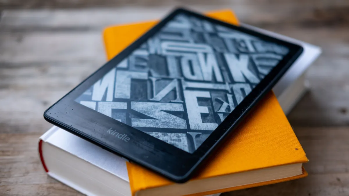 A tablet screen displays a digital library interface with a curated selection of complimentary e-books.