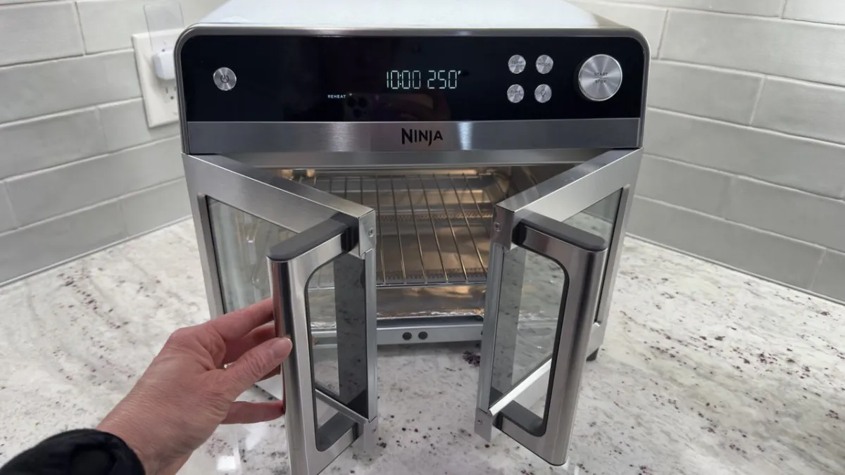 Front view of the Ninja French Door Air Fryer and Countertop Oven showing its control panel and glass door.