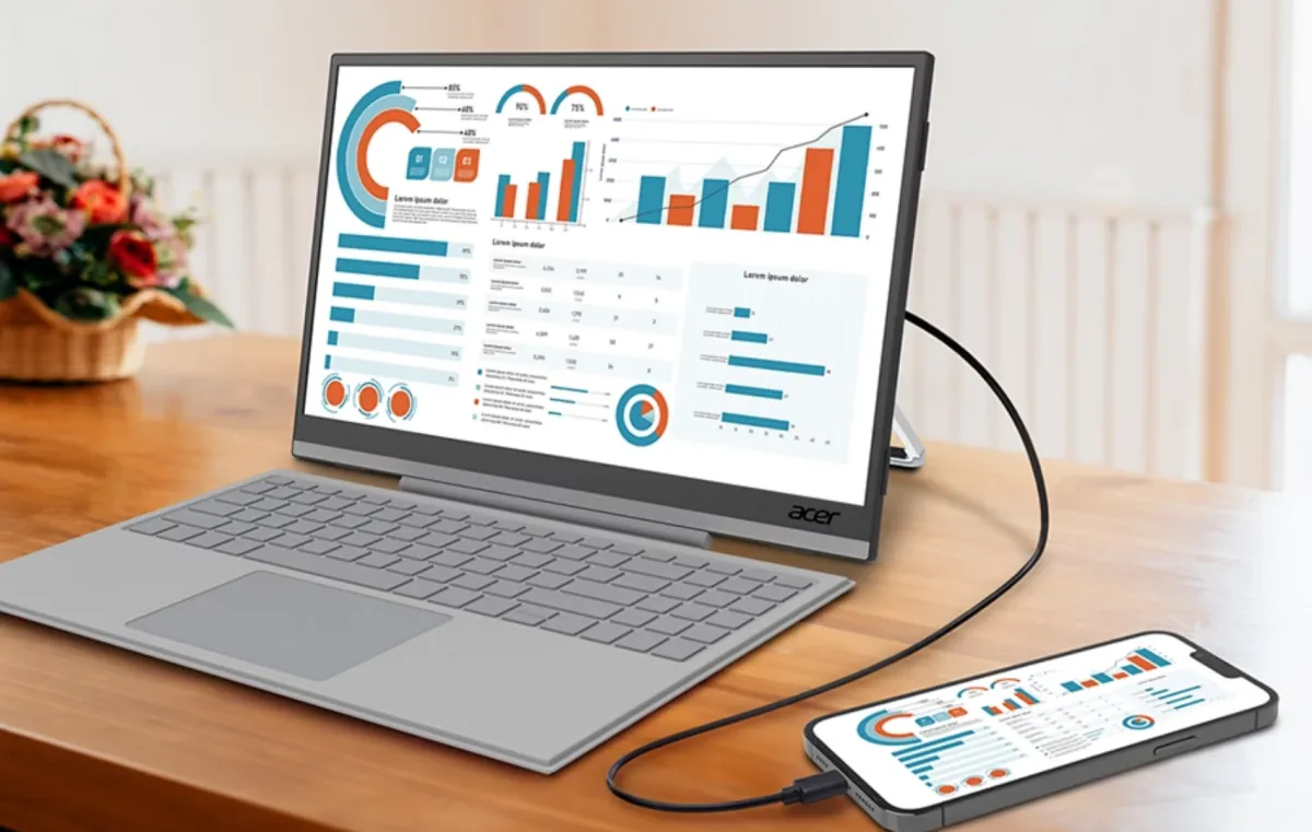 Acer PM1 portable USB-C monitor and magnetic keyboard docked with a smartphone for desktop use.
