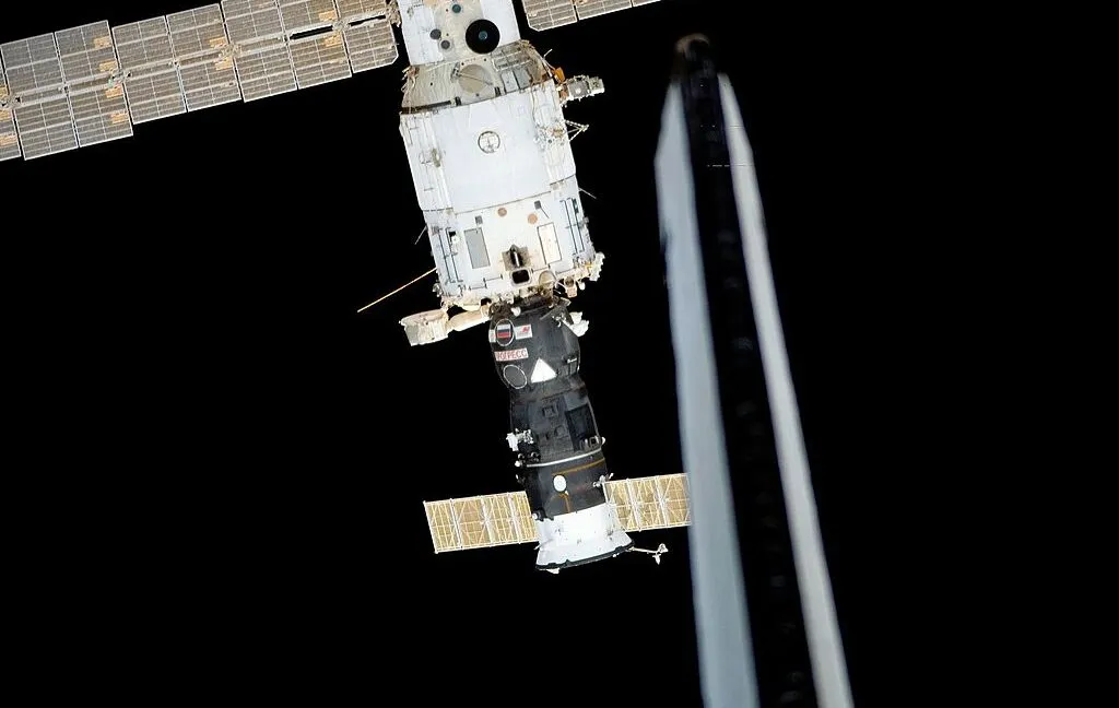 Space station module showing the decommissioned transfer tunnel and structural components in orbit.