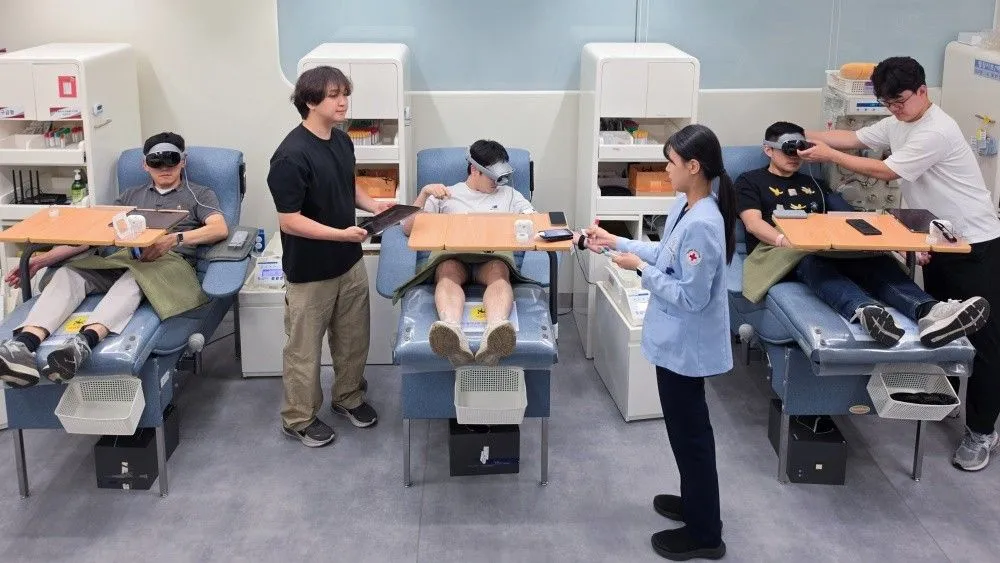 Blood donors wear extended reality headsets for meditation during collection at Samsung and Abbott venues.