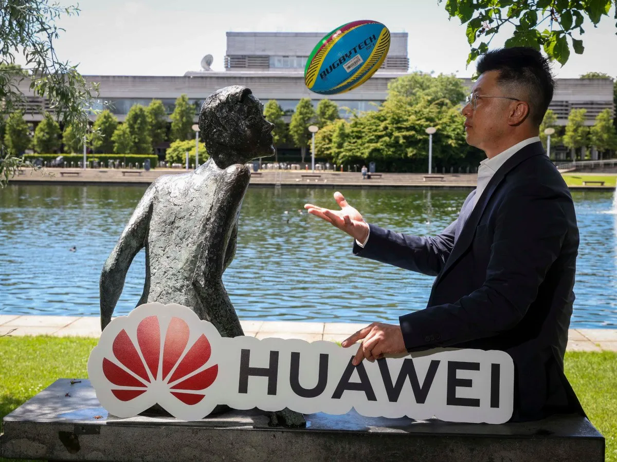 Huawei representatives showcasing renewable energy technology at a UCD pit stop.