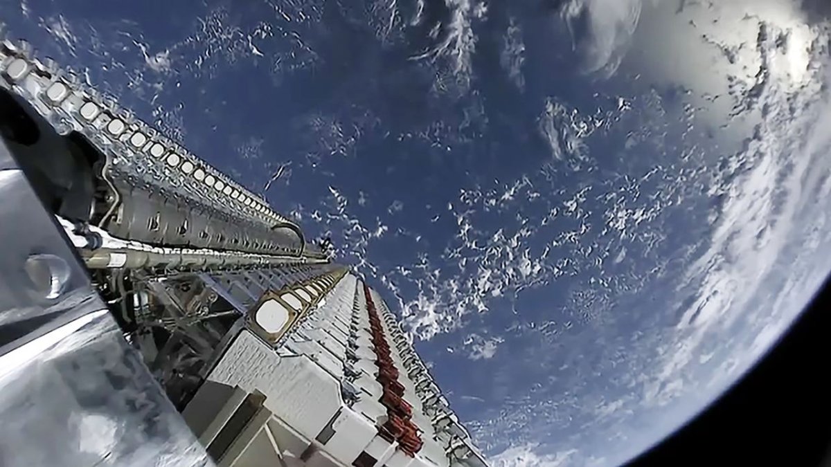 Lithuanian technicians assembling small satellite hardware for commercial space applications.