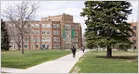 Students walk across a university campus as American colleges rapidly expand artificial intelligence degree programs.
