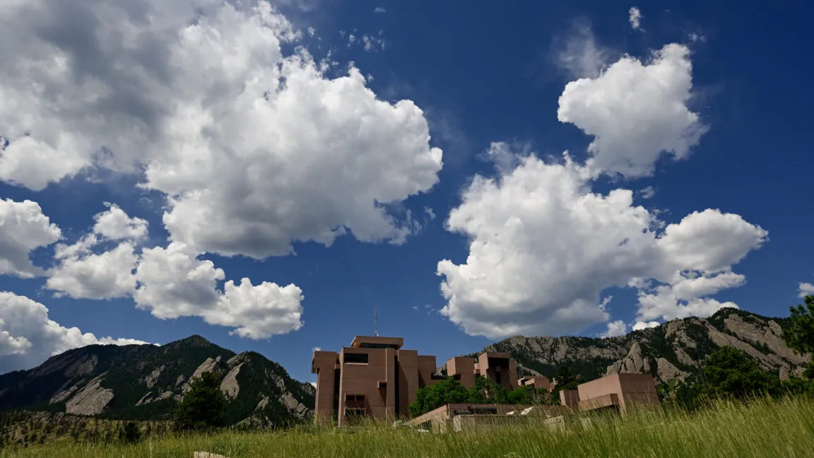The climate research supercomputer center houses extensive server racks used for atmospheric modeling.