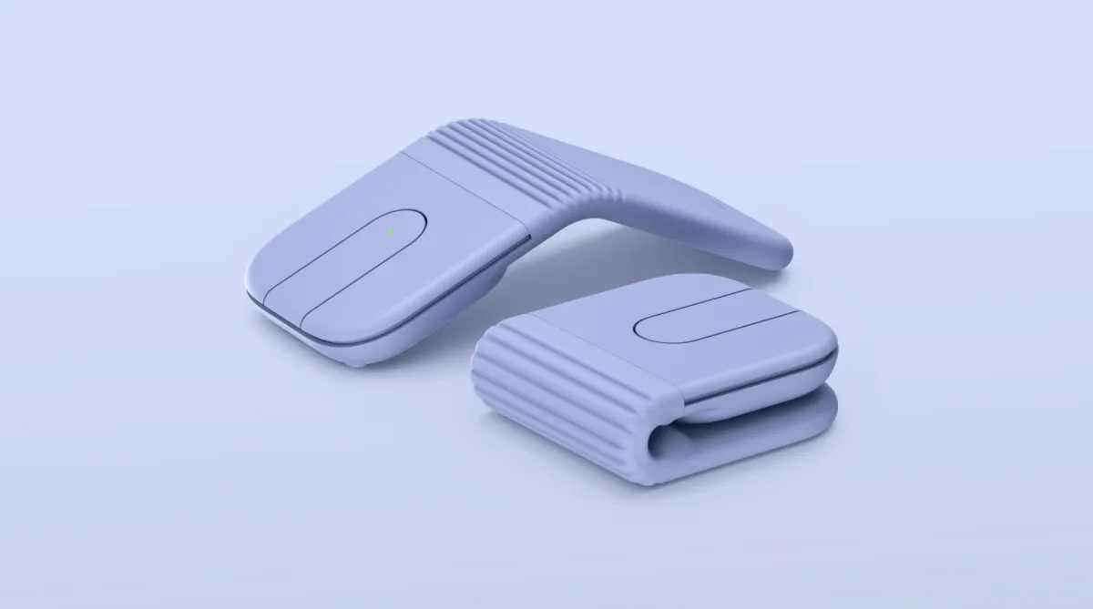 A Logitech Mobi Fold mouse rests in its compact folded configuration.