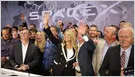SpaceX shares debut at $150 on Nasdaq after $135 IPO pricing, valuing the company at nearly $2 trillion.