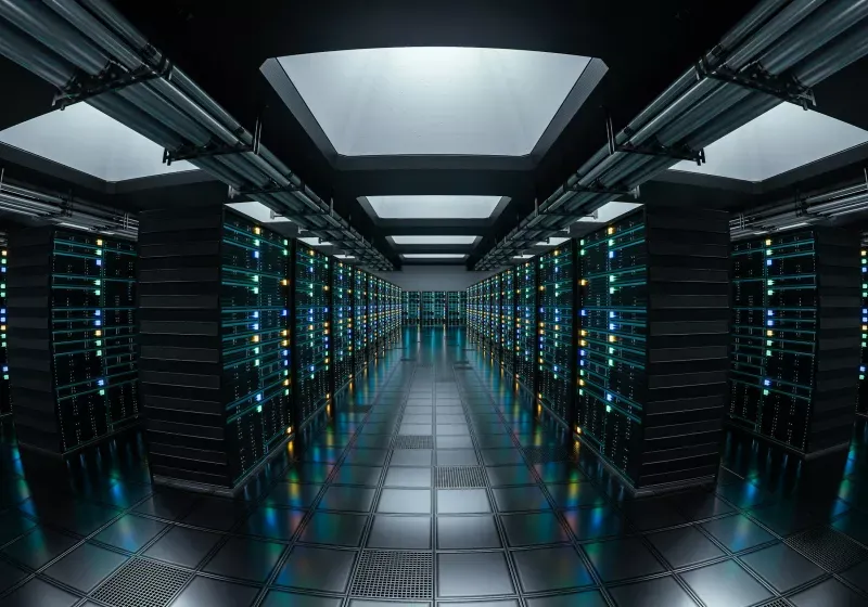 A data center complex stands near cooling towers and electrical infrastructure.