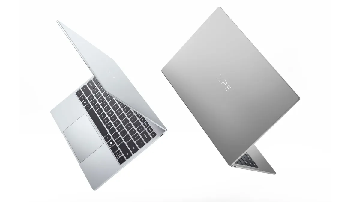 A closed Dell XPS 13 laptop displays its slim silver chassis and touchscreen.