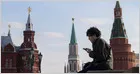 A Russian interior designer uses a virtual private network in a quiet cafe to bypass internet restrictions.