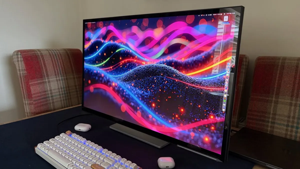 The thirty-two inch Alogic Clarity 6K Touch monitor displays a color calibration chart on its screen.