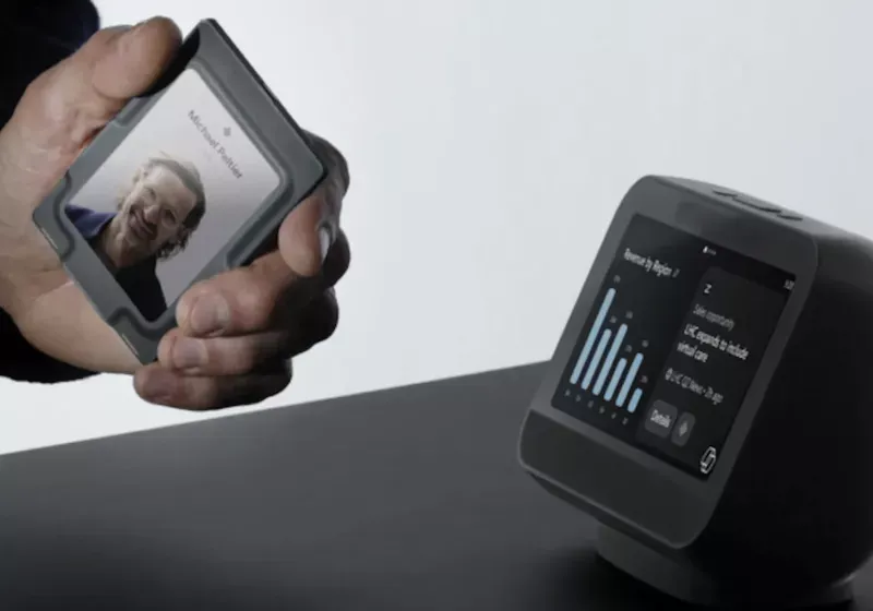 Microsoft wearable AI badge concept featuring a camera and fingerprint sensor for AI agent interaction.