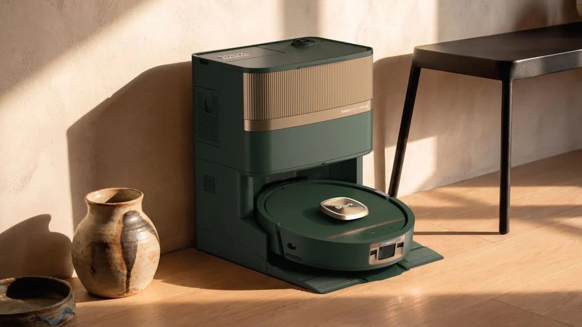 This product image shows a robot vacuum with a satin metallic finish and muted color palette.