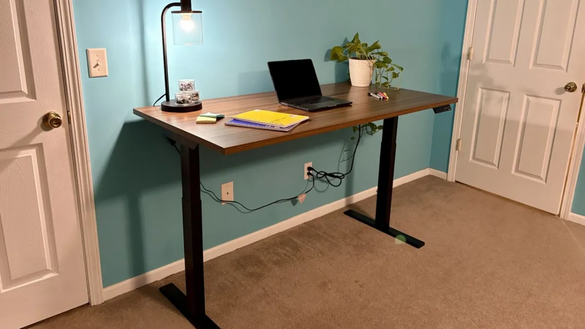 A height adjustable desk features a smooth motorized lift mechanism and a digital control panel.