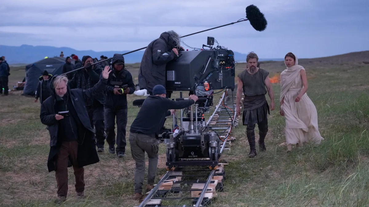 An IMAX 70mm theater screen displays Christopher Nolan The Odyssey during a specialized film presentation.