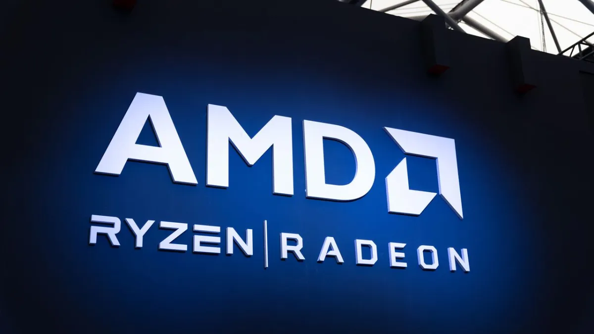 The graphic shows an AMD corporate logo beside a diagram explaining a critical auto-updater vulnerability and bounty policy.