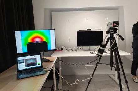 A desk setup features a monitor and adjustable task lighting positioned to reduce screen glare and improve comfort.
