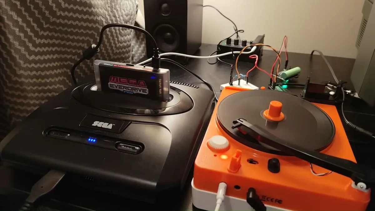 Sega Genesis console connected to a vinyl turntable during an analog data storage experiment.