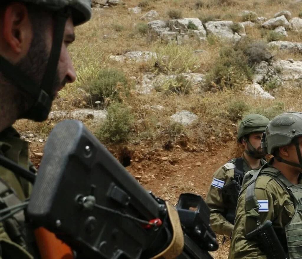 Israeli soldiers confront an armed individual near the Lebanon border at Ramim Ridge.