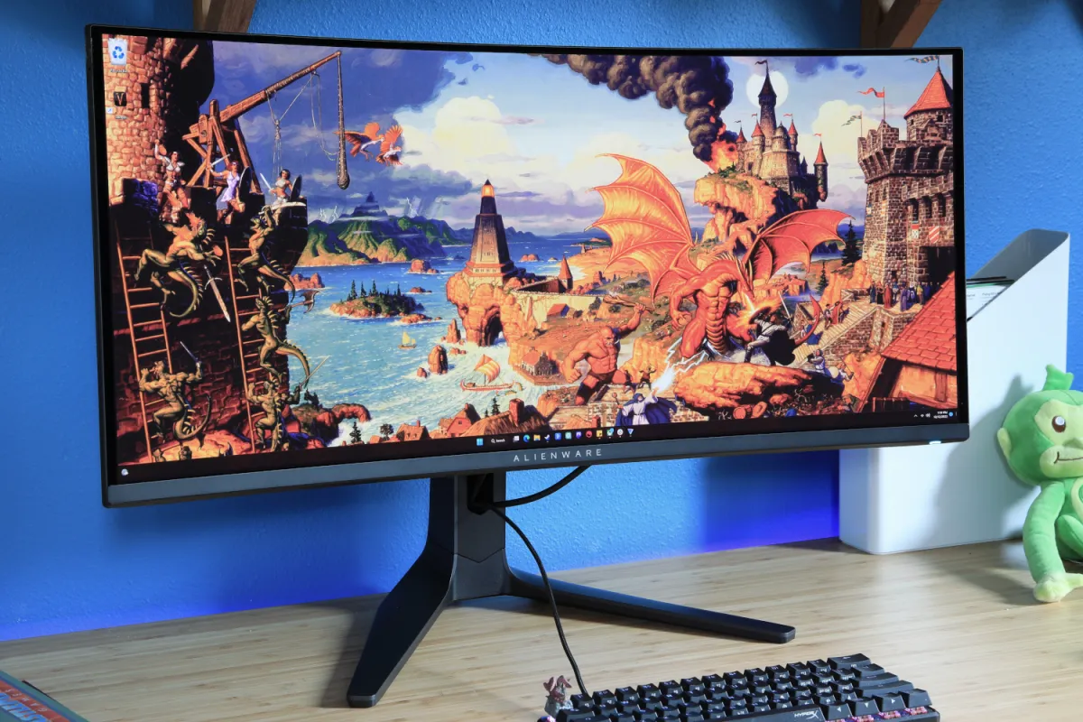 An ultrawide monitor displays a continuous desktop workspace with multiple application windows.