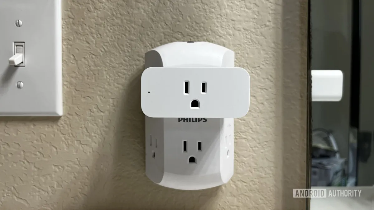 Two Amazon smart plugs with attached power cords and indicator lights